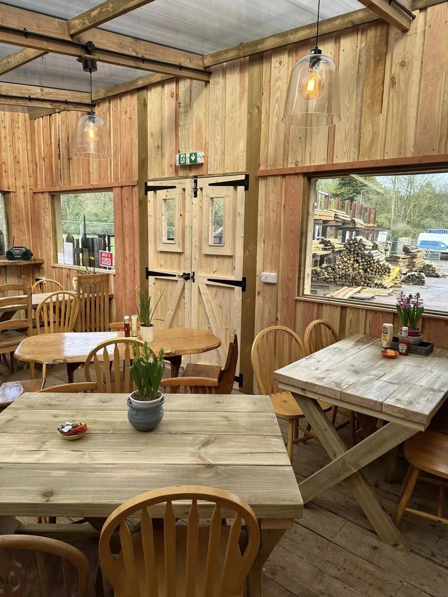 Rustic wooden tables and chairs inside The Coffee Mill